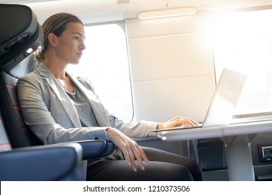 Businesswoman working in first class on a train                                                             - Powered by Shutterstock