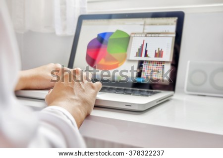 Businesswoman working in his laptop in office