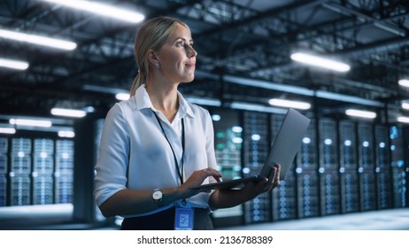 Businesswoman Working with Laptop Computer in Her Office. Skilful Female CEO Runs Business Company During the Evening. Cloud Service, Server Transfer and Analytics concept - Powered by Shutterstock