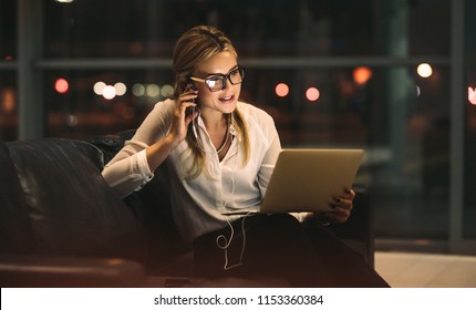 Businesswoman working late in office, doing a video call with digital tablet. Female professional working late in office and making a video call. - Powered by Shutterstock