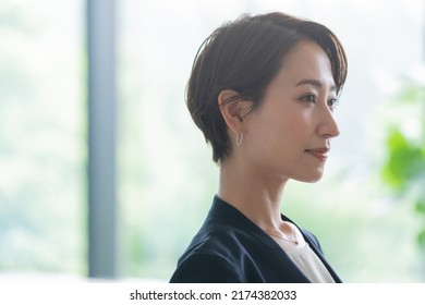  businesswoman working in an office - Shutterstock ID 2174382033