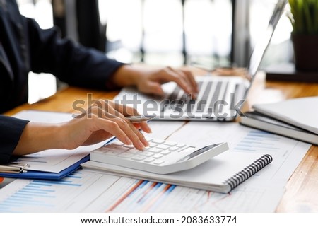 Businesswoman working at office with documents on his desk, doing planning analyzing the financial report, business plan investment, finance analysis concept