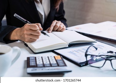 Businesswoman working on Desk office with marketing graph statistics analysis
