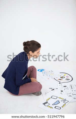 Businesswoman working on icon charts against white background