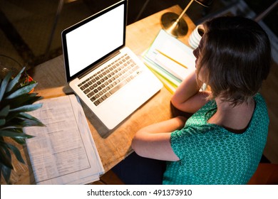 Businesswoman working on laptop in the office - Shutterstock ID 491373910