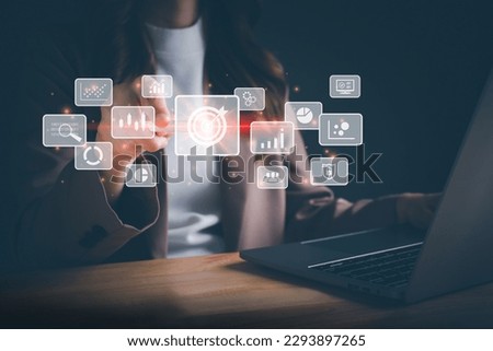 Businesswoman working on laptop and using a stylus pen for big data analytics and business intelligence with chart and graph icons. Goal acheiveement and success concept. Digital screen.