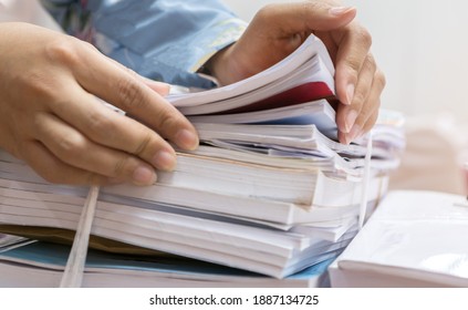 Businesswoman Working In Stacks Of Paperwork Files For Searching Infomation Unfinished Documents About Pile Audit Form On Desk Office And Investigate Financial Doc In Busy Workload