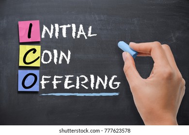 Businesswoman Writing ICO Initial Coin Offering On Blackboard 