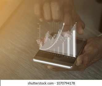 Businesswoman,analytics and financial and bank technology concept, chart from smart phone,Business growth concept - Powered by Shutterstock