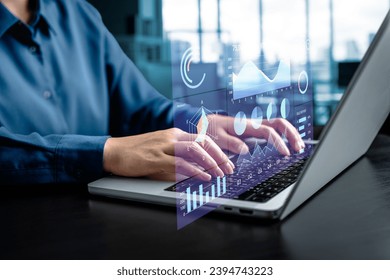 Businesswomen analyze chart data business on a visual screen dashboard laptop, technology devices and screens visible in the background, financial planning, market research, and the stock market. - Powered by Shutterstock