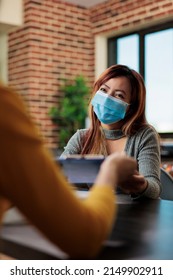 Businesswomen Analyzing Management Graphs During Business Partnership Working At Company Strategy In Startup Office. Entrepreneurs Wearing Medical Face Mask To Prevent Infection With Covid19