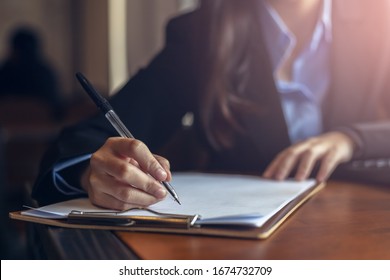 businesswomen calculating, writing and checking for making report financial.  - Shutterstock ID 1674732709