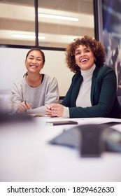 Businesswomen Collaborating In Creative Meeting Around Table In Modern Office