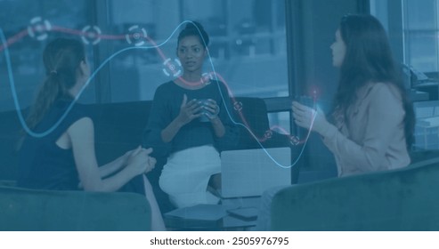 Businesswomen discussing strategy with data visualization image over office setting. teamwork, collaboration, brainstorming, technology, innovation, planning - Powered by Shutterstock