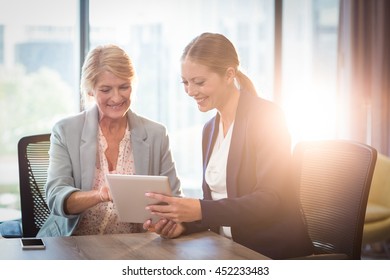 Businesswomen interacting using digital tablet in the office