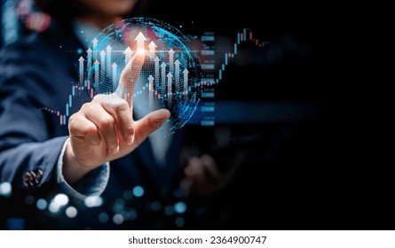 Businesswomen point to virtual screens of graph stock market changes in the global interface, uptrends, growth economic, business strategy development, and find opportunities for investment.