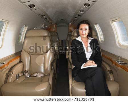 Businesswomen seated in a private jet.