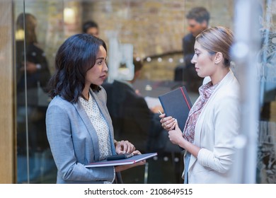 Businesswomen Talking Outside Conference Room Meeting