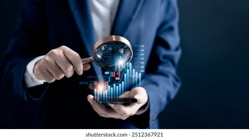 Businesswomen use magnifier glass find stock in stock markets, uptrends, growth economics, business strategy development, and opportunities for investment, take profit from funds, Financial Analyst.  - Powered by Shutterstock