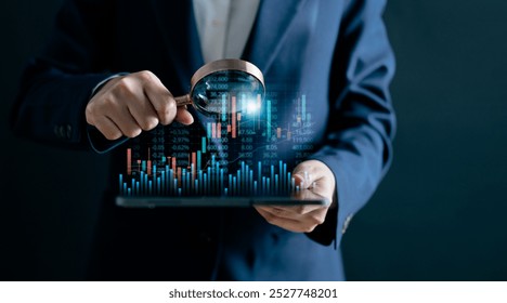 Businesswomen use magnifier glass find stock in stock markets, uptrends, growth economics, business strategy development, and opportunities for investment, take profit from funds, Financial Analyst.  - Powered by Shutterstock