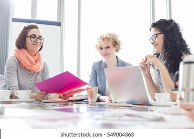 Businesswomen working at desk in creative office