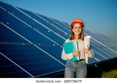 Businesswomen working on checking equipment at solar power plant with tablet checklist, woman working on outdoor at solar power plant.