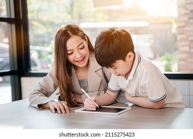 Businses woman working online in cafe with kid. Asian family lifestyle with mobile phone and digital tablet.