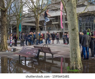 Busking Man On A Large Unicycle Entertaining A Crowd Of People On London's Southbank On A Winters Day. London - 22nd December 2019