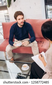 Bussiness Conversation At The Cafe. Handsome Man And Woman Are Talking During Tea Time. Close Up Photo