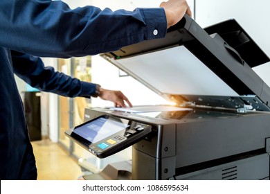 Bussiness man Hand press button on panel of printer, printer scanner laser office copy machine supplies start concept. - Shutterstock ID 1086595634