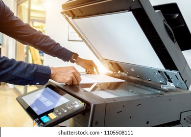 Bussiness man Hand press button on panel of printer, printer scanner laser office copy machine supplies start concept. - Shutterstock ID 1105508111