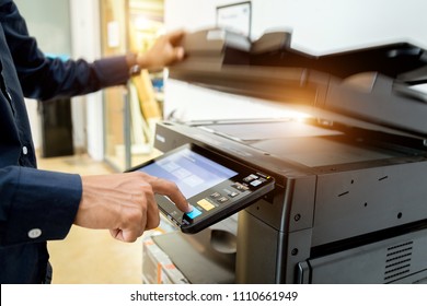 Bussiness man Hand press button on panel of printer, printer scanner laser office copy machine supplies start concept. - Shutterstock ID 1110661949