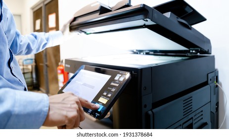 Bussiness man Hand press button on panel of printer, printer scanner laser in office copy machine supplies start concept.
