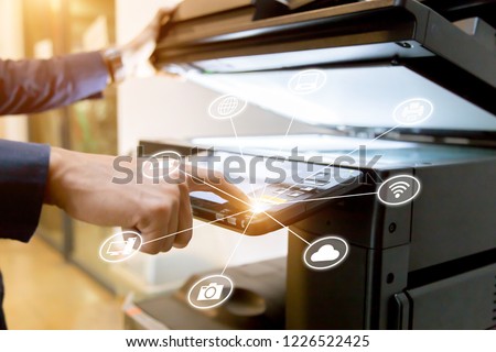 Bussiness man Hand press button on panel of printer with icon technology printer scanner laser office copy machine supplies start concept.