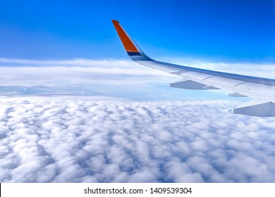 Bussiness And Travel Concept. Aerial View Through Window Inside Aircraft Cabin With Beautiful Blue Sky And Cloud With Sunlight, Copy Space, Top View