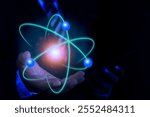 Bussinessman hand holding creative atom. Nuclear fusion concept, endless energy, cheap electricity, future technologies. Science and future concept