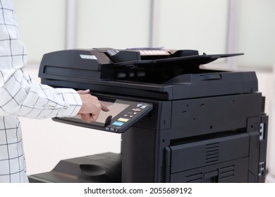 Bussinessman press button on panel of printer photocopier  network , Working on photocopies in the office concept , printer is office worker tool equipment for scanning and copy paper.