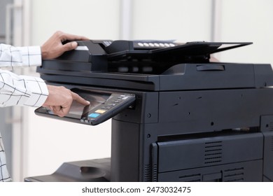 Bussinessman press button on panel of printer photocopier  network , Working on photocopies in the office concept , printer is office worker tool equipment for scanning and copy paper.