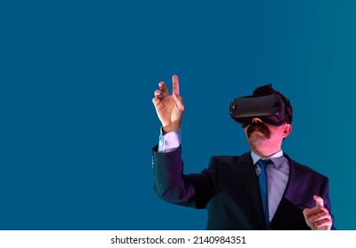 Bussinessman in suit dresscode, experience virtual reality with hologram concept. Includes copy space.