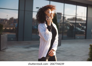 Bussineswoman Spending Work Break Outside Talking On The Phone. Urban Lifestyle. Curly Hair.