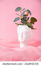 Bust Of A Greek Goddess On A Pastel Pink Background. Minimal Flat Still Life. Beauty Overhead Concept.