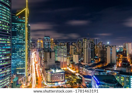 Bustling scene of Ayala Avenue and Makati Skyline at night, during rush hour. Cityscape of Makati, a major CBD in Metro Manila, Philippines.