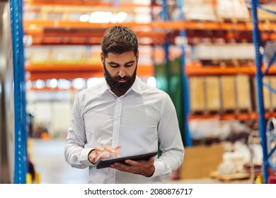 Busy adult, factory manager, checking his schedule, on his tablet. - Shutterstock ID 2080876717