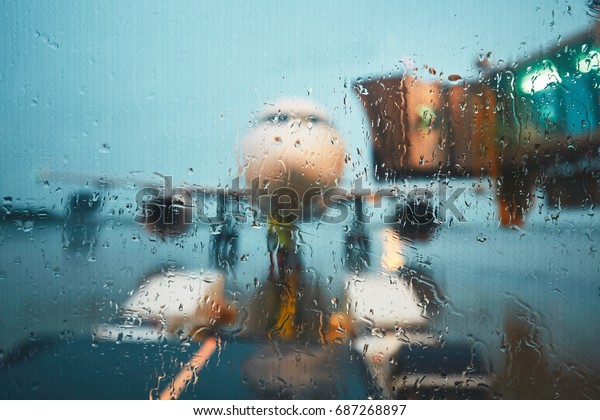 A busy airport in the rain. Push back of the\
airplane before flight.