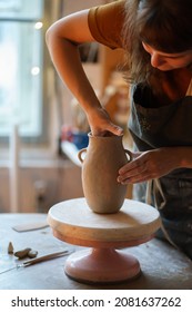 Busy Artist Female Moulding Potter Vase In Studio. Woman Owner Of Craft Tableware Shop Creating New Pottery For Retail Store. Art Classes Hobby Occupation And Small Business Entrepreneurship Concept