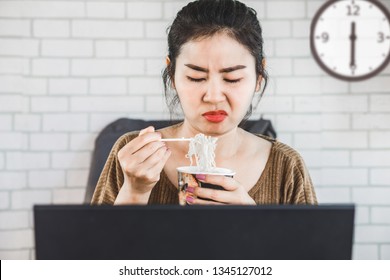 Busy Asian Business Woman Eating Noodle At Work For Lunch Time With Unhappy Face 