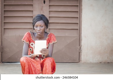 Busy Business Woman Symbol: Young African Girl Reading Tablet PC IPad