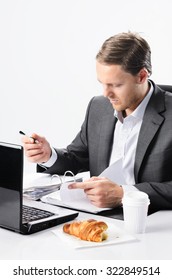 Busy Businessman Has To Sign Documents And Look Over Contracts, No Time To Finish Breakfast Croissant