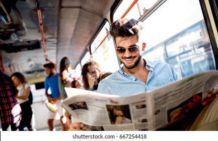 The busy businessman sits in the bus and reads the newspapers. - Powered by Shutterstock