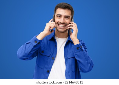 Busy Businessman Talking Using Two Phones, Isolated On Blue Background